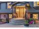 Inviting front porch with decorative accents and seating, leading to a charming home entrance at 20520 E Regency Way, Parker, CO 80138