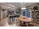 Modern kitchen with stainless steel appliances, sleek cabinetry, and a dining area with stylish lighting at 20520 E Regency Way, Parker, CO 80138