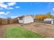 House backyard with a partially grassy area and dirt patches at 1502 Carmelita Ct, Platteville, CO 80651