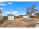 Large backyard with two sheds and a dirt area at 1502 Carmelita Ct, Platteville, CO 80651