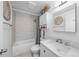 Clean bathroom with a white vanity, bathtub, and tiled shower at 1502 Carmelita Ct, Platteville, CO 80651