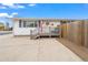 House exterior with a front porch, walkway, and wood fence at 1502 Carmelita Ct, Platteville, CO 80651