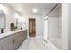 Updated bathroom featuring dual sinks, modern fixtures, neutral paint, and a combined shower-tub at 2418 Coach House Loop, Castle Rock, CO 80109