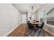 Open dining room with wood floors, a chandelier, and a view of a large wall mirror at 2418 Coach House Loop, Castle Rock, CO 80109