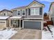 Exterior elevation of the house featuring a two-car garage and front porch at 2418 Coach House Loop, Castle Rock, CO 80109