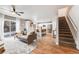 Open-concept layout featuring a spacious living room that connects to a modern kitchen and staircase at 2418 Coach House Loop, Castle Rock, CO 80109