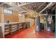 Functional basement with work table, exposed ductwork, and painted concrete floor at 55 S Grant St, Denver, CO 80209