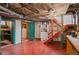 Basement featuring painted concrete floor, utility access, painted walls, and stairway to upper level at 55 S Grant St, Denver, CO 80209