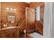 Rustic bathroom with wood-paneled walls, classic fixtures, and a tub, creating a cozy and inviting spa-like atmosphere at 55 S Grant St, Denver, CO 80209