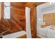 Unique bathroom showcasing a wood-paneled tub, elegant shower fixtures, and a cozy view into an adjacent bedroom at 55 S Grant St, Denver, CO 80209