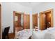 Inviting bedroom with wood-trimmed doorways, layered bedding, and bright interiors, offering a harmonious blend of comfort at 55 S Grant St, Denver, CO 80209