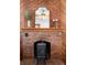 Rustic brick fireplace with a decorative mantle, vintage details, and a charming wood stove at 55 S Grant St, Denver, CO 80209