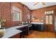 Rustic kitchen with exposed brick, stainless steel appliances, and black cabinetry at 55 S Grant St, Denver, CO 80209