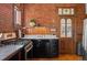 Charming kitchen with brick accent wall, stainless steel range and wood trim at 55 S Grant St, Denver, CO 80209