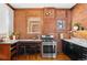 Functional kitchen featuring stainless steel range, wood accents, and brick walls at 55 S Grant St, Denver, CO 80209