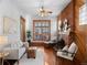 Inviting living room featuring a brick fireplace, natural light, hardwood floors, and cozy seating at 55 S Grant St, Denver, CO 80209