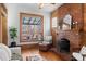 Bright living room with a brick fireplace, large window, hardwood floors, and comfortable seating at 55 S Grant St, Denver, CO 80209