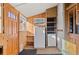 Mudroom with wood accents, built-in shelving, storage, full-size refrigerator, and exterior access at 55 S Grant St, Denver, CO 80209