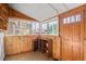 Bright sunroom featuring wood paneled walls, built-in storage, and natural light streaming through multiple windows at 55 S Grant St, Denver, CO 80209