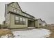 Landscaped backyard with a patio and partial snow cover at 1853 Hickory Ave, Erie, CO 80516