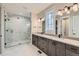 Elegant bathroom with double vanity, marble flooring, and a large shower at 1853 Hickory Ave, Erie, CO 80516