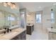 Spa-like bathroom with double vanity, marble flooring, and a soaking tub at 1853 Hickory Ave, Erie, CO 80516