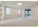 Spacious bedroom with carpet flooring and sliding glass doors to a deck at 1853 Hickory Ave, Erie, CO 80516
