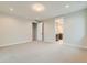 Large bedroom with carpet, an ensuite bathroom, and a door to the hallway at 1853 Hickory Ave, Erie, CO 80516
