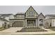 Two-story craftsman style home with gray brick and green siding at 1853 Hickory Ave, Erie, CO 80516