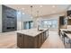 Modern kitchen with a large island, quartz countertops, and stainless steel appliances at 1853 Hickory Ave, Erie, CO 80516