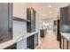 Modern kitchen with dark cabinetry and marble countertops at 1853 Hickory Ave, Erie, CO 80516