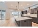 Modern kitchen with dark cabinetry, marble island, and stainless steel appliances at 1853 Hickory Ave, Erie, CO 80516