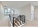Open upper hall with modern railing and carpet at 1853 Hickory Ave, Erie, CO 80516