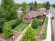 Aerial view of a brick home with lush landscaping, patio, and inviting outdoor spaces at 2300 Jasmine St, Denver, CO 80207
