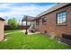 Lush backyard featuring a pergola, outdoor dining area, and well-manicured lawn at 2300 Jasmine St, Denver, CO 80207