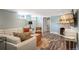 Finished basement living area with stone fireplace and ample seating at 2300 Jasmine St, Denver, CO 80207