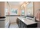 Charming bathroom featuring double vanity, shower and bath, complemented by stylish fixtures at 2300 Jasmine St, Denver, CO 80207