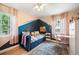 Stylish bedroom with vibrant wall colors, comfortable bedding, and ample natural light at 2300 Jasmine St, Denver, CO 80207