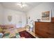 Cozy bedroom with a daybed, a desk, and a large dresser providing a comfortable personal space at 2300 Jasmine St, Denver, CO 80207