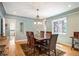 Elegant dining room with a wooden table, chandelier lighting, and natural light from the window at 2300 Jasmine St, Denver, CO 80207