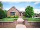 Charming brick home with manicured front yard, inviting walkway, and classic curb appeal in a desirable neighborhood at 2300 Jasmine St, Denver, CO 80207