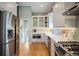 Modern kitchen with stainless steel appliances, white cabinetry, hardwood floors, and ample counter space at 2300 Jasmine St, Denver, CO 80207