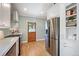 Bright kitchen with stainless steel refrigerator, range and access to the outdoors at 2300 Jasmine St, Denver, CO 80207