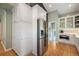 Spacious kitchen featuring ample white cabinetry, stainless steel refrigerator, and hardwood floors at 2300 Jasmine St, Denver, CO 80207
