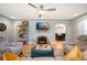 Relaxing living room features a fireplace, TV, ceiling fan and comfortable seating area, perfect for Gathering at 2300 Jasmine St, Denver, CO 80207