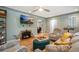 Inviting living room with a cozy fireplace, modern ceiling fan, and comfortable seating arrangement at 2300 Jasmine St, Denver, CO 80207