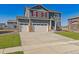 Charming two-story home with a three car garage, green lawn, and red shutters at 4211 Sandstone Dr, Mead, CO 80504