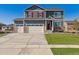 Charming two-story home with a three car garage, green lawn, and red shutters at 4211 Sandstone Dr, Mead, CO 80504