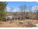 Back of brick home surrounded by trees and beautiful landscaping at 15846 W Bayaud Dr, Golden, CO 80401