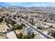 Sweeping aerial view of a charming neighborhood nestled against a scenic mountain backdrop under a clear blue sky at 15846 W Bayaud Dr, Golden, CO 80401